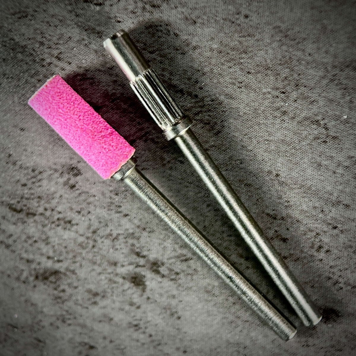 alternative product image of Phenomenail® Precision Seamless Sanding Bands 240/180 Grit. Nail prep, shaping, refining, and surface smoothing. Image shows 2 drill bits Phenomenail® Precision Carbide Mini Mandrel 3.1mm one with and one without the sanding band