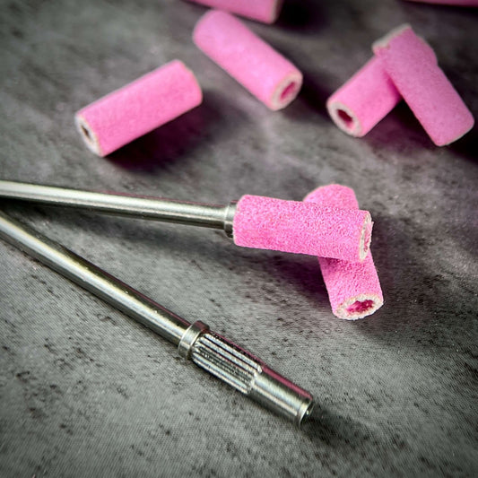 product image of Phenomenail® Precision Seamless Sanding Bands 240/180 Grit. Nail prep, shaping, refining, and surface smoothing. Image shows 2 drill bits Phenomenail® Precision Carbide Mini Mandrel 3.1mm one with and one without the sanding band. loose sanding bands in background.