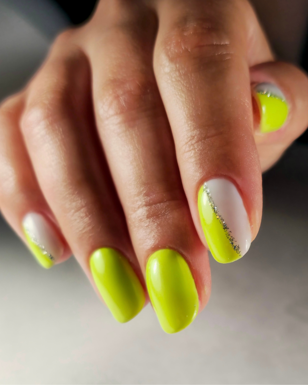 Close-up of nails featuring Da'Bomb neon yellow gel polish from the Phenomenail™ M.E.T.A Pro PIGM-A range

