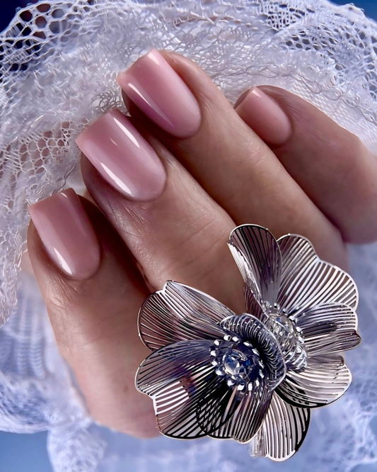 A close up of a hand with square shaped nails with Phenomenail™ STRUCT-R MASQUERADE, a light pink