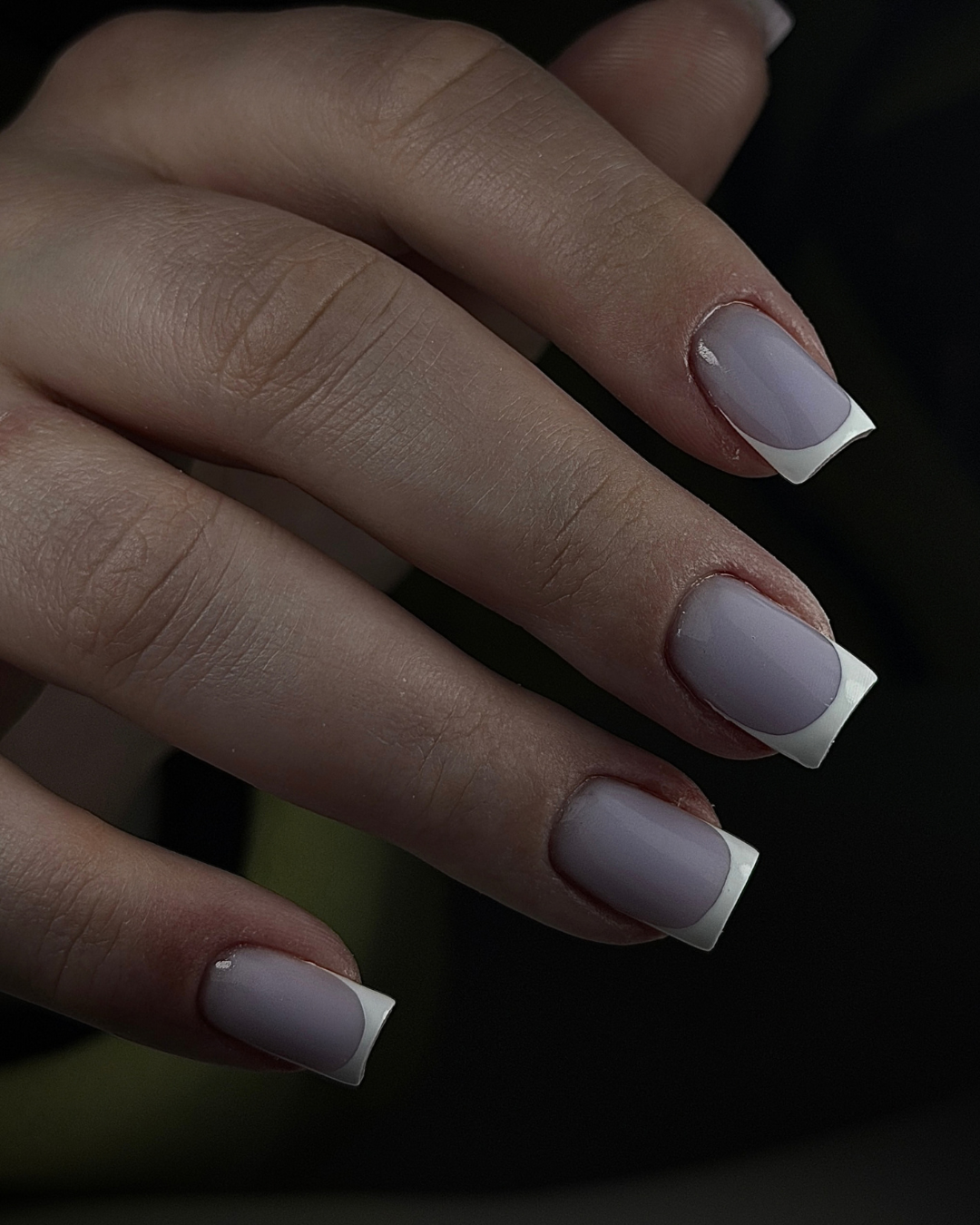 A close-up of a hand with a French manicure featuring Shiva highly pigmented opaque white PIGM-A Gel Polish 
