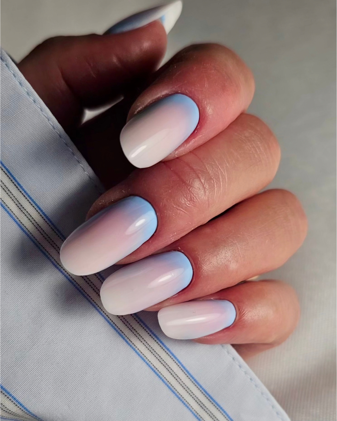 Close-up of nails featuring Smurfberry soft pastel blue gel polish from the Phenomenail™ M.E.T.A Pro PIGM-A range
