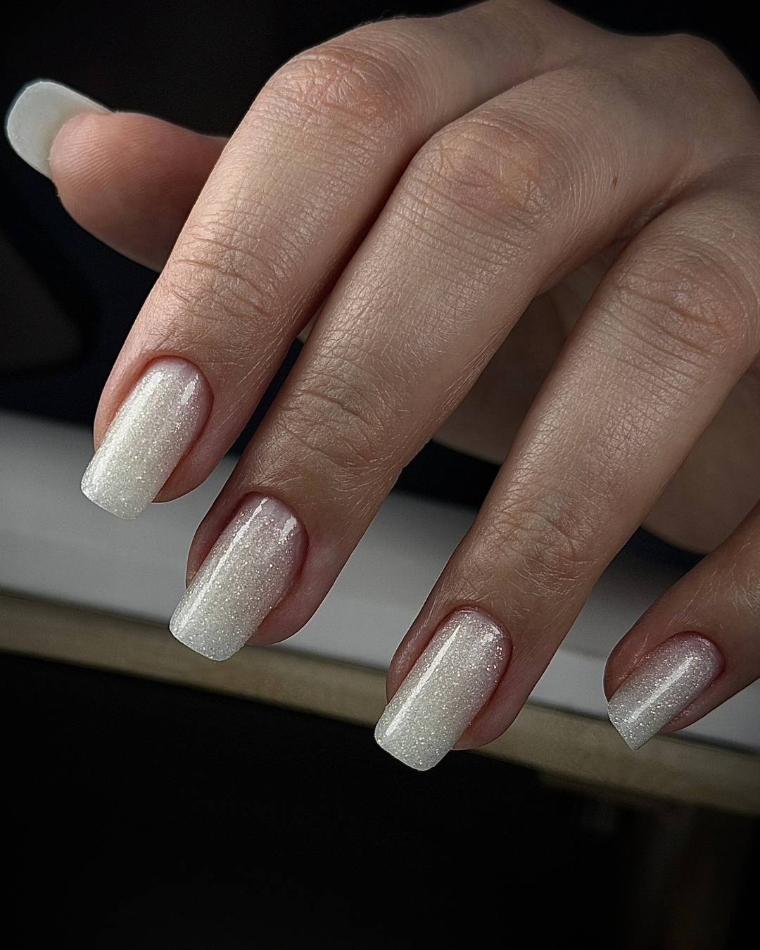 A close up of a hand with square shaped nails wearing Phenomenail™ STRUCT-R VEILED
