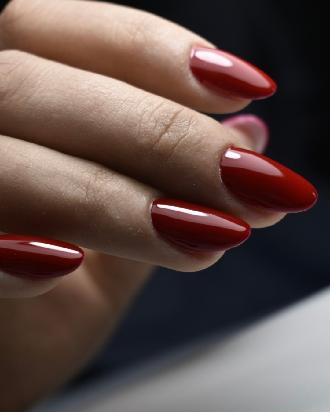 Close-up of Yuna red gel polish from Phenomenail™ M.E.T.A Pro Gel System on  almond/oval nails